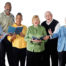 Men and women together singing while holding music in their hands