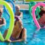 women in a pool holding flexible exercise pool noodles
