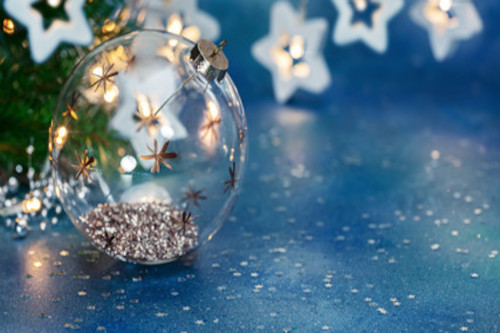 glass ornament painted with stars on the outside and glitter on the inside