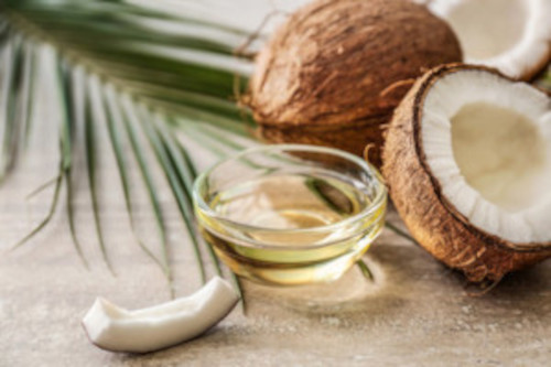 Picture of coconut and a bowl full of coconut oil
