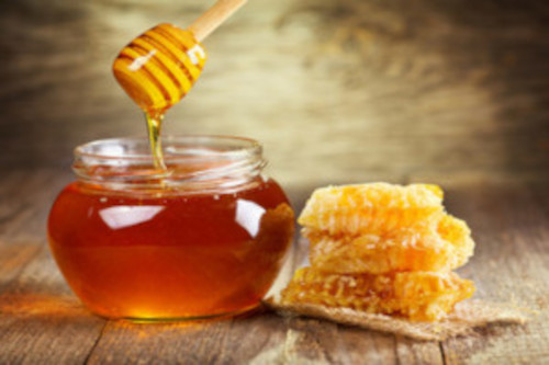 jar of honey and a honey comb