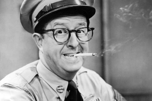 Photo of Phil Silvers smoking a cigarette