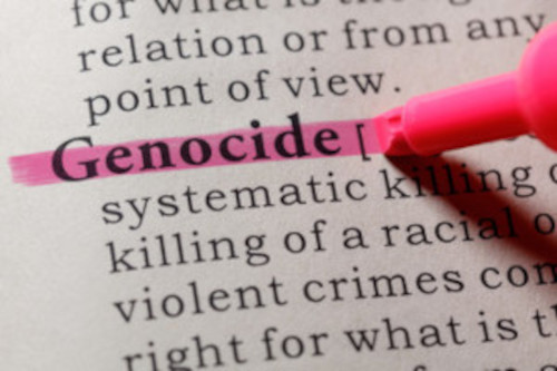 Photo of a highlighter on the word genocide in the dictonary.