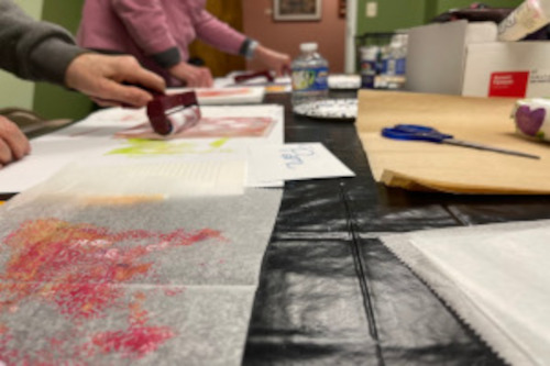 mono-printing-500 Photo of craft paper and a person using a roller with paints