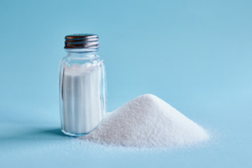 salt picture of a salt shaker filled with salt and a mound of salt next to it.