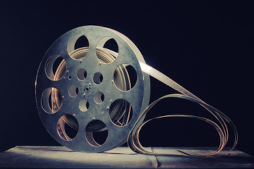 picture of a reel with a movie strip on it.