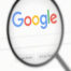 the google home page with a magnifying glass over the work google.