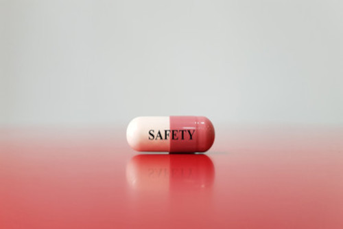medication Picture of a pink and white medication capsule with the word safety written in black