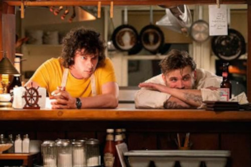 A photo from the movie Tony. Two characters leaning over a kitchen counter