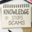 A picture of a notebook that says knowledge stops scams