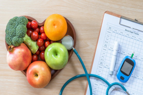 picture of fruits and vegetables in a hard shaped bowl, a stethoscope, blood glucose test and a clipboard with paper. Advertising a class on diabetes