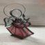 photo of a stained glass angel with a pink dress, white wings and a metal halo
